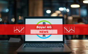Ein Laptop steht auf einem Tisch, auf dem Bildschirm ist deutlich das Logo von Bayer zu sehen, mit einem Bayer AG NEWS Banner