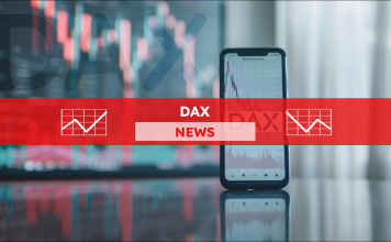 ein Smartphone auf eine reflektierenden Tisch, das Börsendiagramme anzeigt, mit einem verschwommenen Hintergrund, der die Buchstaben DAX projiziert,  mit einem DAX NEWS Banner